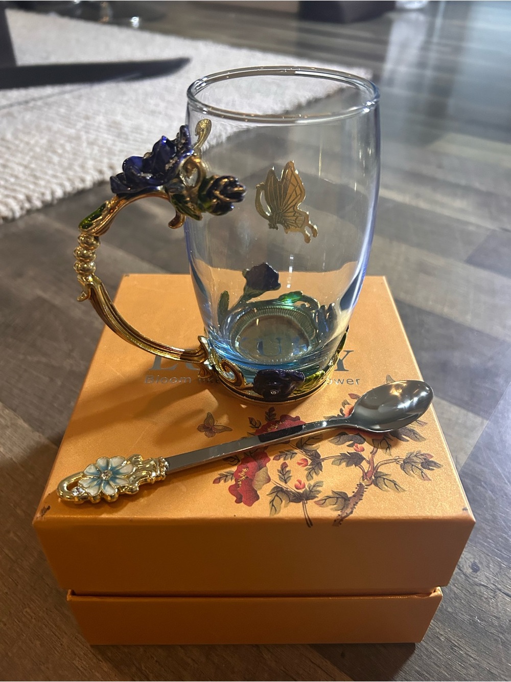 Ornate Blue Glass Teacup with Gold Floral Handle and Matching Spoon